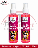 Two bottles of Pet Peer Daily Dry Bath spray for pets, featuring pink liquid and bright magenta labels with cartoon dog graphics, shown on a white background with Petsmart branding.