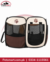 A two-compartment pet carrier bag shown against a white background with a red and black Petsmart logo at the top left and a red contact banner at the bottom. The carrier has cream-colored fabric panels, dark brown lower sections, black mesh pockets, and brown paw print graphics on the front compartments.