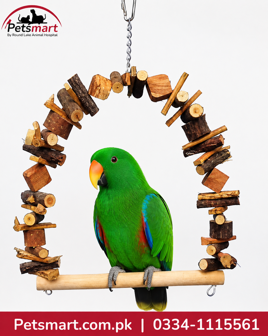 A green parrot with a yellow beak and blue wing feathers perched on a wooden hanging toy made of stacked wood blocks and branches, shown against a light gray background. The Petsmart logo is visible in the top left, and a red contact banner is at the bottom.